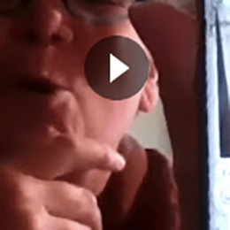 Thumbnail; Person's talking, only nose, mouth and hand visible. Screenshot with video play button.