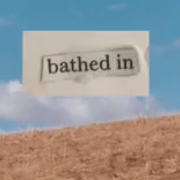 Thumbnail; dry grass landscape with blue sky and cloud. Typed text on paper "bathed in" pasted on top of sky.